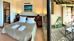 a bedroom with a bed with two towels on it at A ALTEZZA Palombaggia in Porto-Vecchio +87 photos