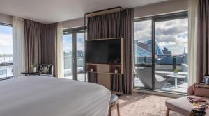 a hotel room with a bed and a large window at The Spencer Hotel in Dublin