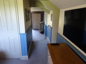 a hallway with a flat screen tv and a door at The Groes Inn in Conwy