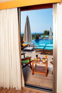 a balcony with a view of a swimming pool at Alacati VillaRenk in Alaçatı