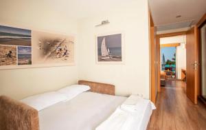 a bedroom with two beds and pictures on the wall at Alacati VillaRenk in Alaçatı