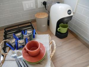 a coffee maker sitting on a counter with a cup of coffee at Flat 61 in Turin