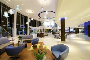 a lobby with blue chairs and a table in a building at Hotel Mykonos in Santiago