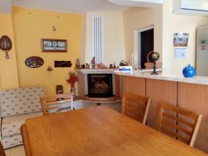 a dining room with a table and a fireplace at Guest House Prodanov in Sozopol