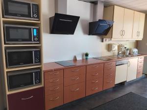 a kitchen with two microwaves and a counter top at Motel-Stuhr in Stuhr