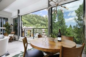 a dining room with a table with a bottle of wine at Durant 6D in Aspen