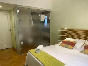 a bedroom with a large bed and a shower at N4U Guest House Florence in Florence