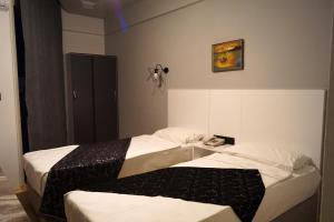 Postel nebo postele na pokoji v ubytování Aslan Sand & City Hotel