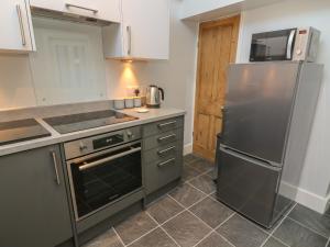 a kitchen with a stainless steel refrigerator and appliances at Number Thirty-Nine in Ulverston