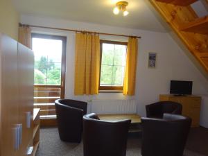 a room with a table and chairs and a window at Penzion Bona in Rokytnice nad Jizerou