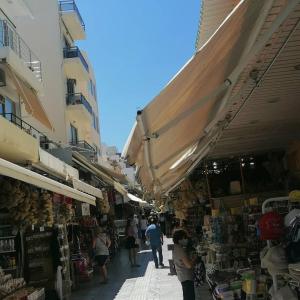 a group of people walking through an outdoor market at Kliklis Apartment in Heraklio