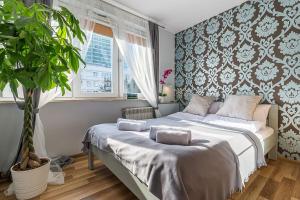 um quarto com uma cama e um vaso de plantas em L Rent like home - Panska 3 em Varsóvia