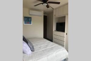 a bedroom with a bed and a ceiling fan at Departamento Ambar en Puerto Vallarta in Puerto Vallarta