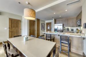 a kitchen and dining room with a table and chairs at Riverfront Resort in Avon
