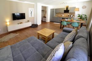 sala de estar con sofá azul y mesa en Pretti Apartments - NEUE moderne Wohnung im Herzen Bambergs - absolut zentral, en Bamberg