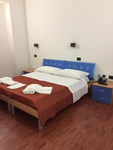 A bed or beds in a room at Asselta Hotel