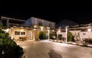 a patio lit up at night with lights at Apartments Marija Vukas in Dubrovnik