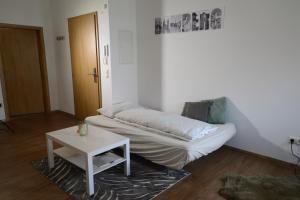 um quarto com uma cama e uma mesa em Pretti Apartments - NEUES stilvoll eingerichtetes Apartment im Zentrum von Bamberg em Bamberg