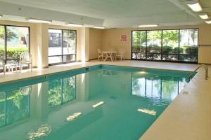 a large swimming pool with blue water in a building at Quality Inn & Suites Boone - University Area in Boone