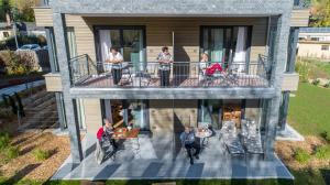 a group of people on the balcony of a house at INVITA Natur-Chalets Penthouse in Bad Dürrheim