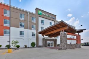 a hotel with a sign on the front of a building at Holiday Inn Express & Suites - Effingham, an IHG Hotel in Effingham