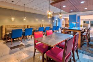 a dining room with tables and blue chairs at Holiday Inn Express & Suites - Effingham, an IHG Hotel in Effingham