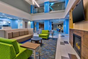 a lobby with a couch and a fireplace at Holiday Inn Express & Suites - Effingham, an IHG Hotel in Effingham