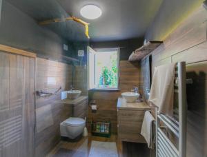 a bathroom with a toilet and a sink at The Lodge in San Siro +14 photos