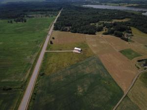 an aerial view of a field with a bus on a road at Motel Golden Fox in Zeļčava