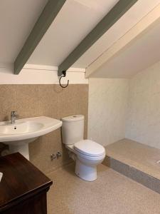 a bathroom with a toilet and a sink at O'Soleil Chalets Self Catering in La Digue