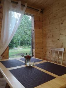 a dining room with a table and a window at Brīvdienu māja "Raudiņi" in Kaltene