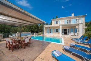 an external view of a villa with a swimming pool at Villa Pelagos in Tselendáta