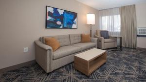 a living room with a couch and a table at Candlewood Suites - Cleveland South - Independence by IHG in Independence
