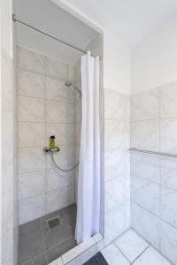 a shower with a shower curtain in a bathroom at aday - Apartment suite 1 Aalborg Center in Aalborg