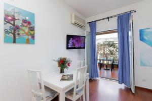a dining room with a white table and chairs at Holiday rental St Peter's area in Rome