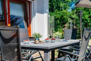 a table with bowls and plants on top of it at Villa Waldnest in Tanne