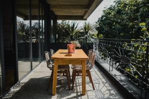 a wooden table and chairs on a balcony at IN Gallery Hotel & Spa in Korçë