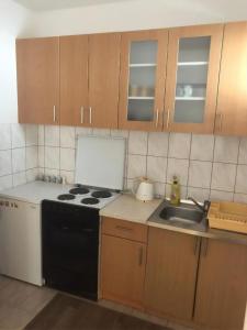 a kitchen with a stove and a sink at Cheap house near the center of the city in Mostar +5 photos