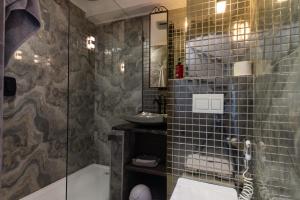 a bathroom with a shower and a tub and a sink at Sea front designer apartment in Ballito +24 photos