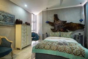 a bedroom with a bed with two towels on it at Sea front designer apartment in Ballito