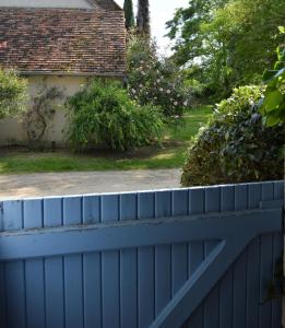 a blue fence in front of a house at Gite De Saba in La Celle-Condé