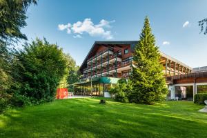 a building with a green lawn in front of it at Alpenland St Johann in Sankt Johann im Pongau