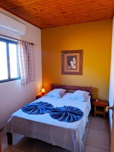 a bedroom with a bed with a blue blanket on it at CASA BONITA in Bonito