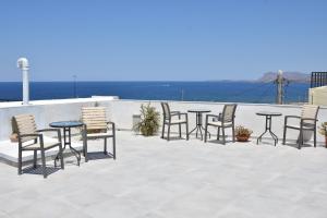 a group of chairs and tables on a patio at Porto Chania in Chania