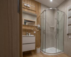 een badkamer met een douche en een glazen douchecabine bij Apartament MOUNTSEA Pobierowo , Grunwaldzka in Pobierowo +18 foto's