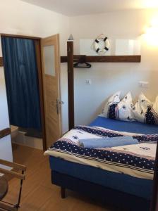 a bedroom with a bed with blue sheets and pillows at Casa del Mar free Parking Only Adults for Young U45yrs in Międzyzdroje