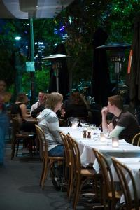 a group of people sitting at a table in a restaurant at The Maisonette in Sydney