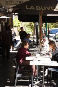 a group of people sitting at tables in a restaurant at The Maisonette in Sydney