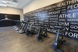 a room with chairs and a wall with words on it at Astron Suítes Mondial Salvador by Nobile in Salvador