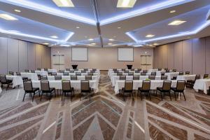 a conference room with tables and chairs in it at Holiday Inn La Mirada Buena Park by IHG in La Mirada